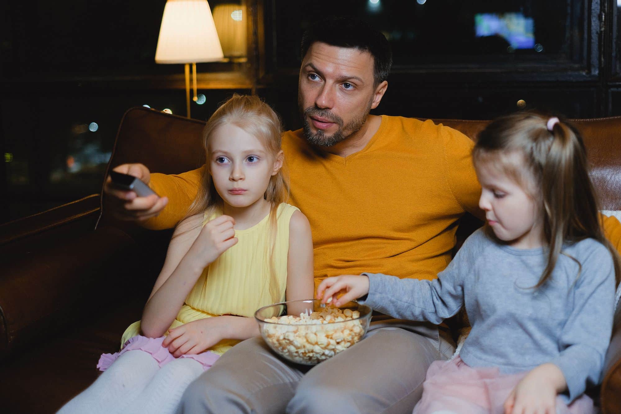A family watching TV on the sofa