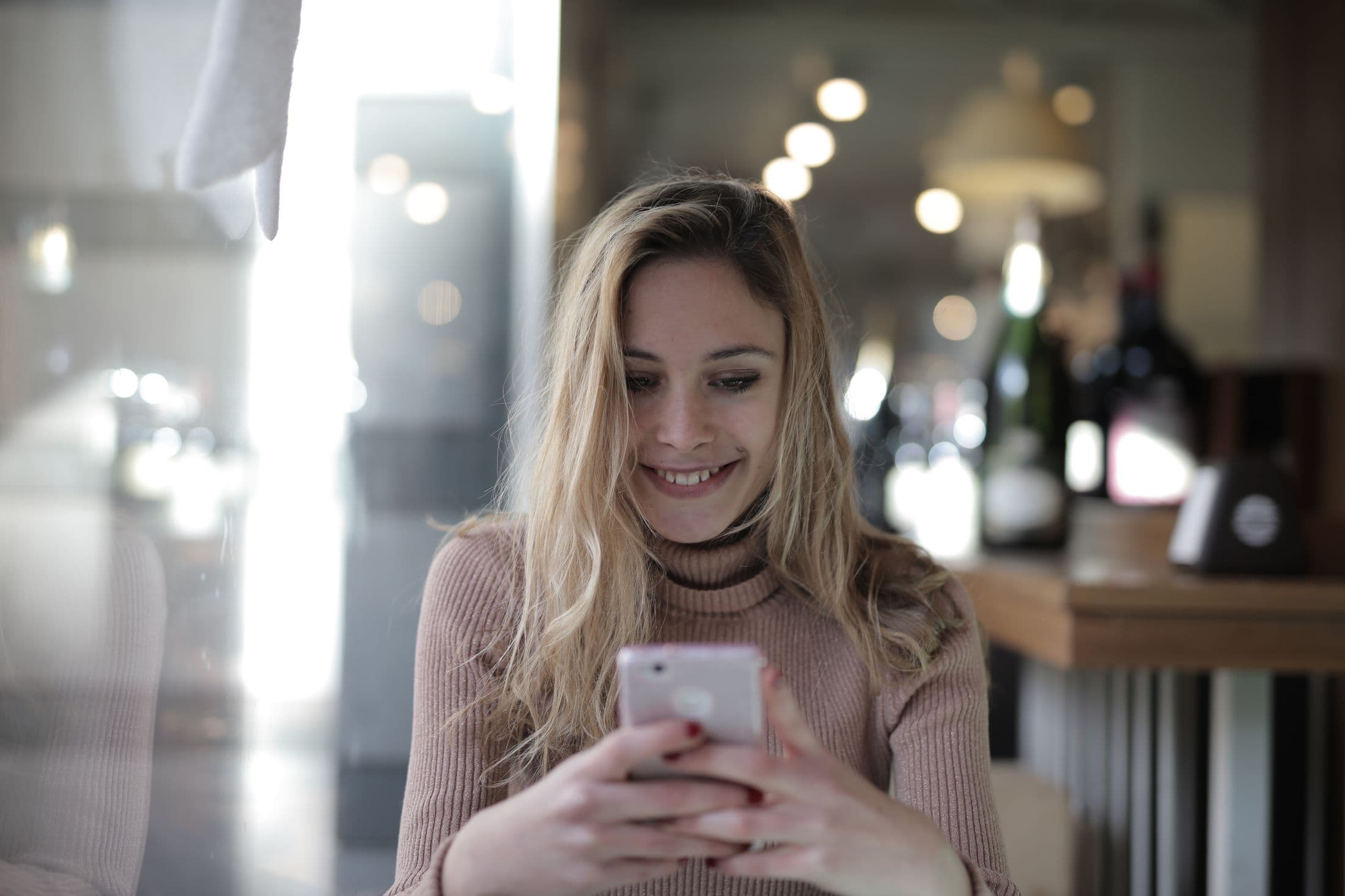A woman using a smartphone in a café